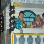 Teresa, Kathy and Max throw beads to the crowd