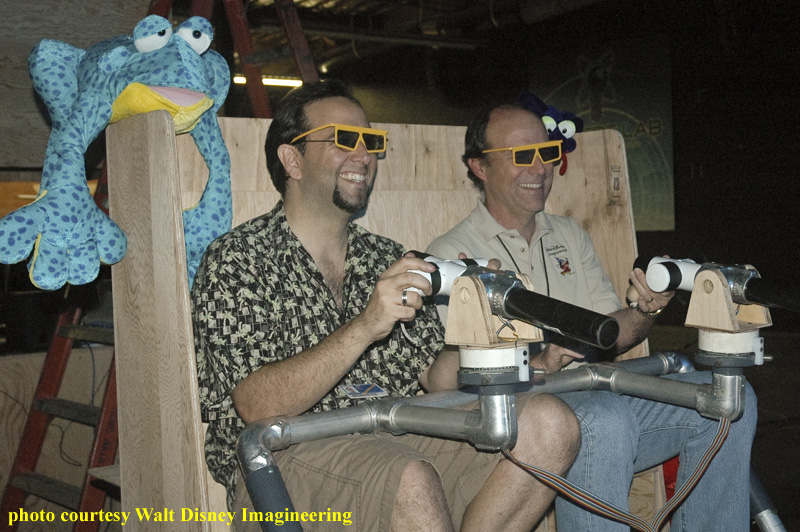Seated, from left to right in the photo, are Disney Imagineers Robert Coltrin and Kevin Rafferty, the co-concept designers for Toy Story Mania!