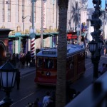 DL DCA Holiday Newsboys riding the trolley down the decorated street (600x400)